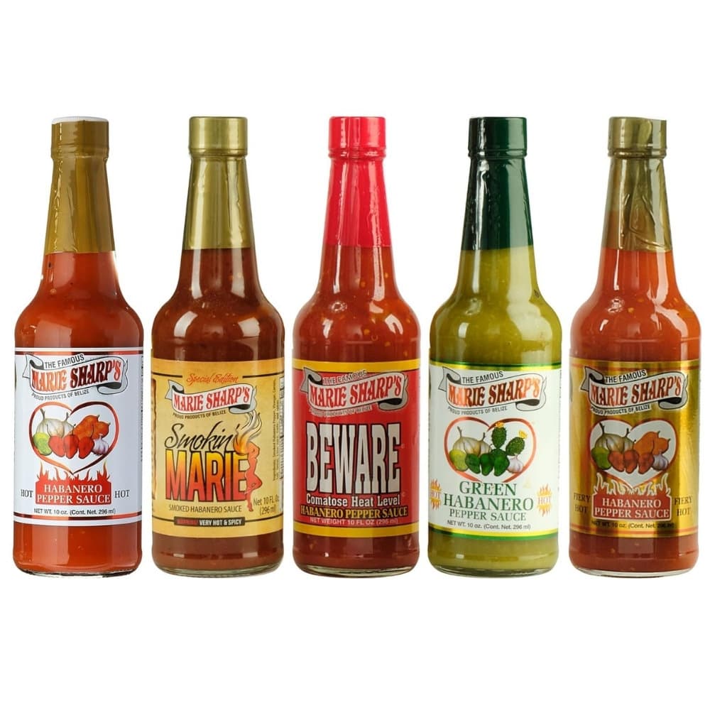 Five bottles of Marie Sharp's habanero pepper sauce in various flavors and heat levels.