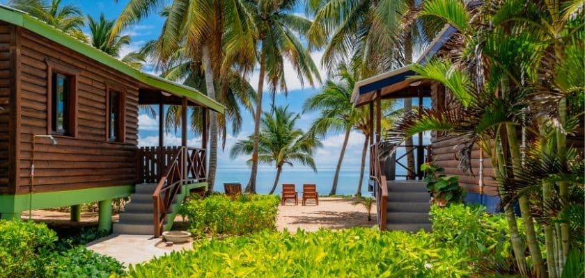 A closeup of two standalone beachfront cabins with private porches.